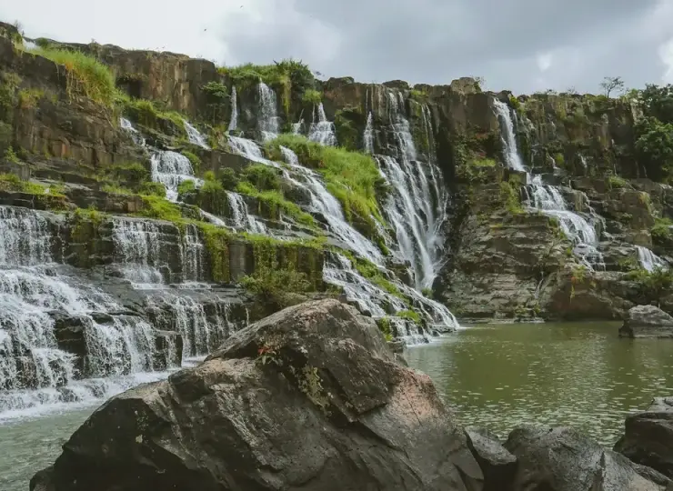 Terraced rock shelves and falling water at Pongour Falls near Da Lat