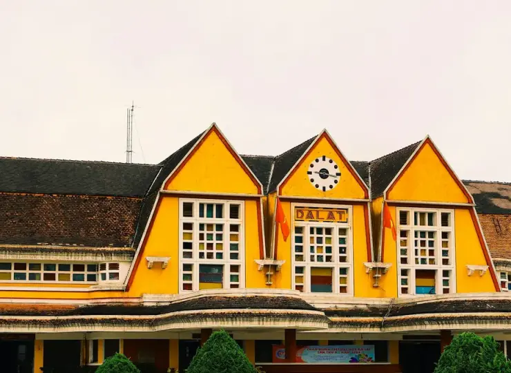 Yellow clock tower facade of Da Lat Railway Station