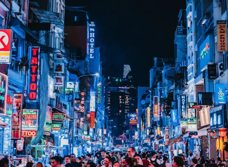 Crowds and neon signs on Bui Vien Walking Street at night in Ho Chi Minh City