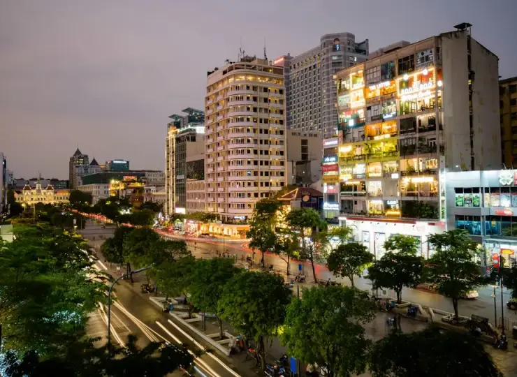 Night view over Nguyen Hue Walking Street with lit high-rise buildings in Ho Chi Minh City