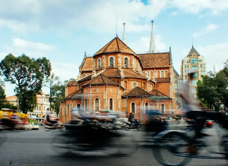 Traffic passing Notre-Dame Cathedral Basilica of Saigon in Ho Chi Minh City