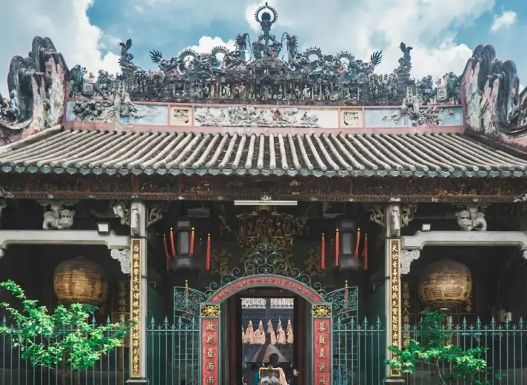 Woman taking a photo inside Thien Hau Pagoda in Ho Chi Minh City