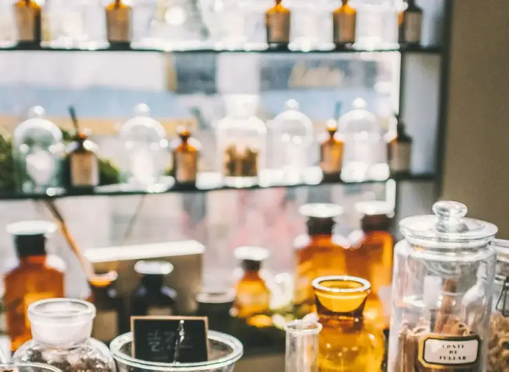 Glass jars and herbal medicine bottles in a traditional medicine display