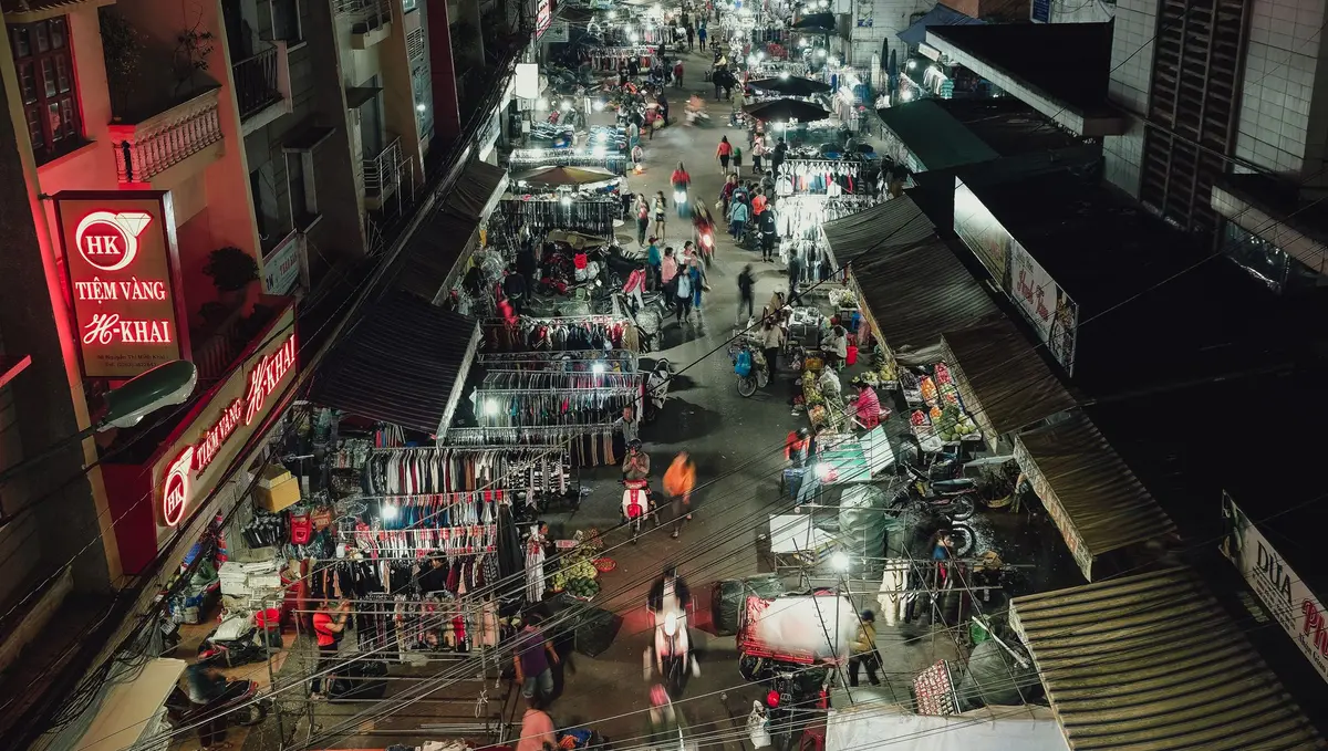 Busy Da Lat night market with stalls and evening shoppers