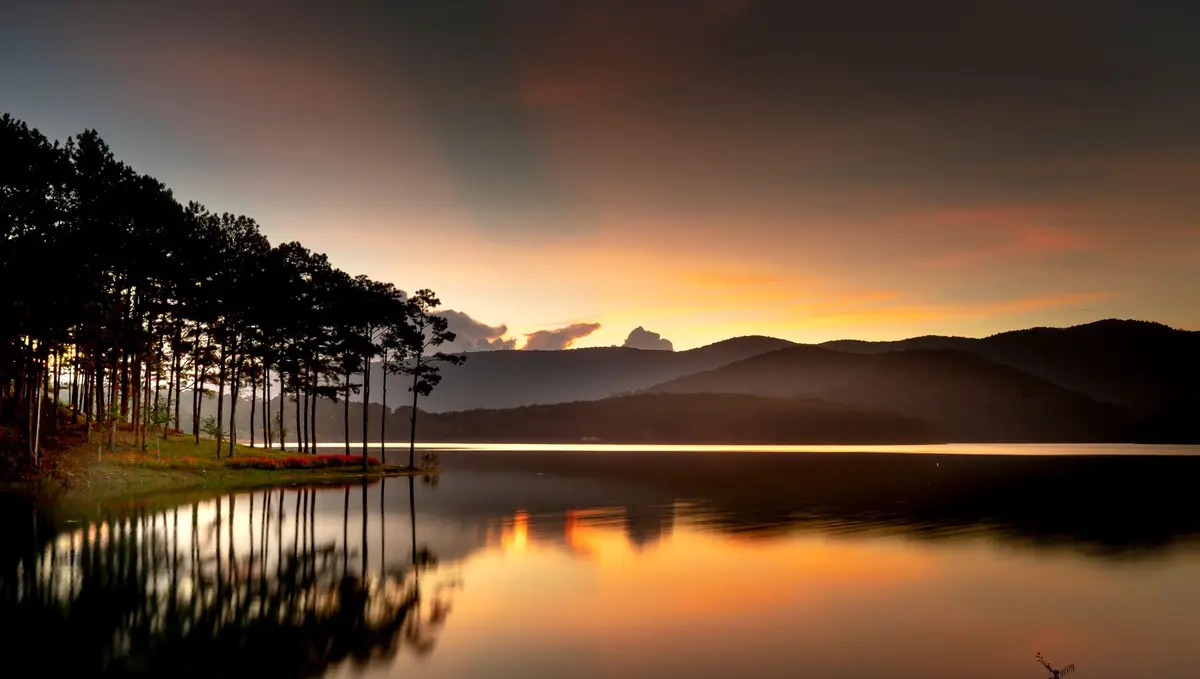Sunset over Tuyen Lam Lake and pine-covered hills near Da Lat