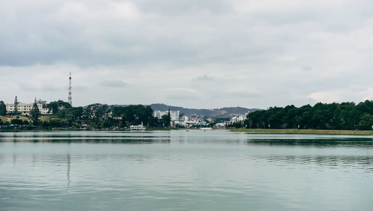 Xuan Huong Lake and the Da Lat skyline under cloudy skies