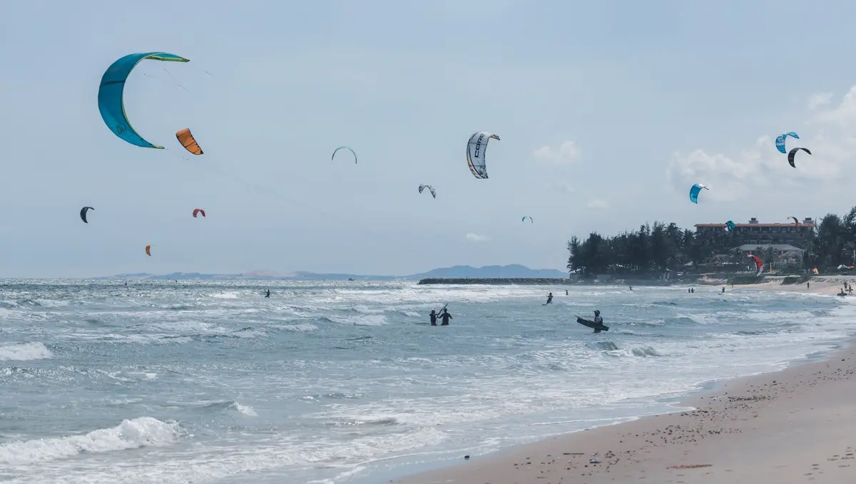 Kitesurfers riding the waves along the Mui Ne coast