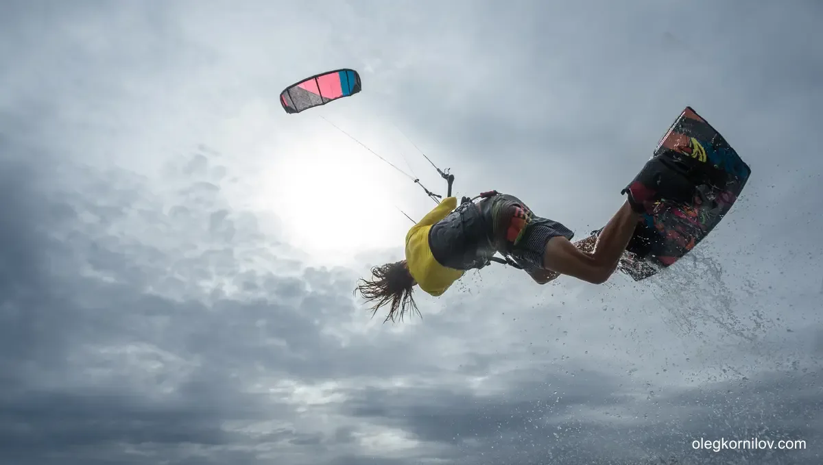 Experienced kitesurfer completing an aerial board maneuver
