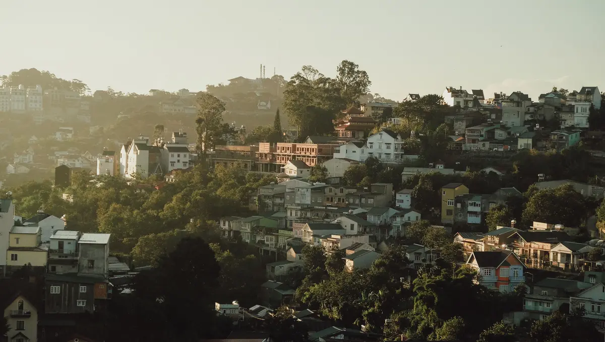 Green residential hills in northern Da Lat in warm morning light