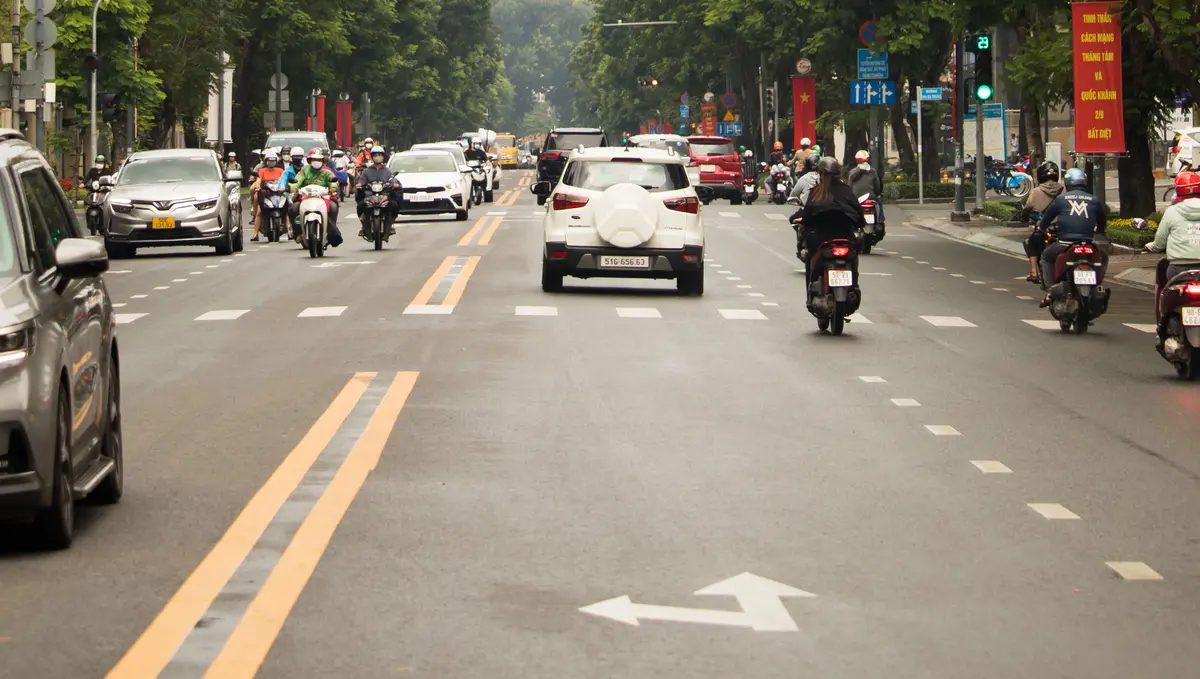 Traffic on a tree-lined street in Phu Nhuan, Ho Chi Minh City